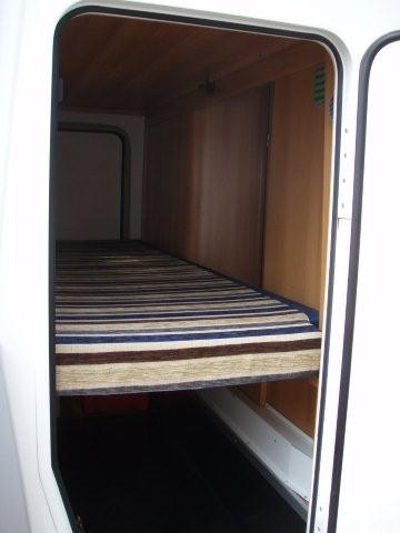 pass through storage for boards, sails under bunk
